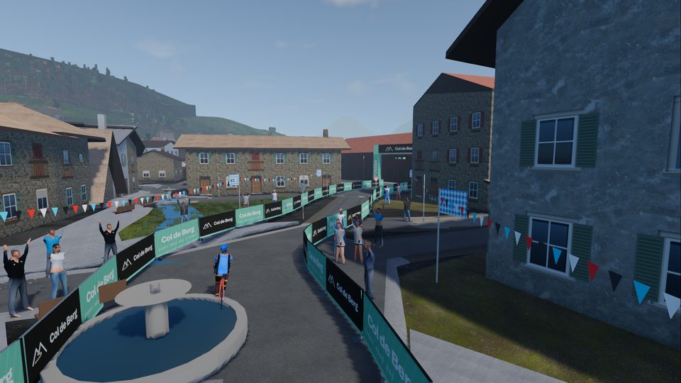 The run-in to the finish in Mittenwald: the arch, the barriers, a fountain from the map and a crowd under Bavarian flags